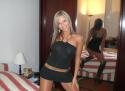 23814_Brunette_woman_with_blonde_highlights_in_black_clubwear_dress.