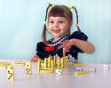 24476470972-cheerful-child-playing-with-small-toys-sitting-at-the-table.