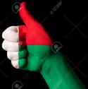 28837_13207903-Hand-with-thumb-up-gesture-in-colored-madagascar-national-flag-as-symbol-of-excellence-achievement-g-Stock-Photo.