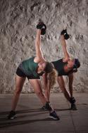 45748_shutterstock_117052024_Two_pretty_ladies_women_lifting_kettlebell_weights_over_their_shoulders.