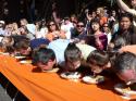 72616_pumpkin-festivals-travel-news-half-moon-bay-pie-eating-contest-full.